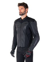 Model wearing the Alpinestars Faster V3 Airflow Leather Jacket in Black Black, sport riding motorcycle jacket with perforated leather and stretch panels, paired with black pants and black gloves with red accents, sleek race-derived style.