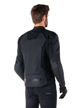 Alpinestars Faster V3 Airflow Leather Jacket, Black, Rear view of a man wearing a sport leather motorcycle jacket, featuring perforated back panels, stretch inserts, and Alpinestars branding on the lower hem, paired with black pants and gloves