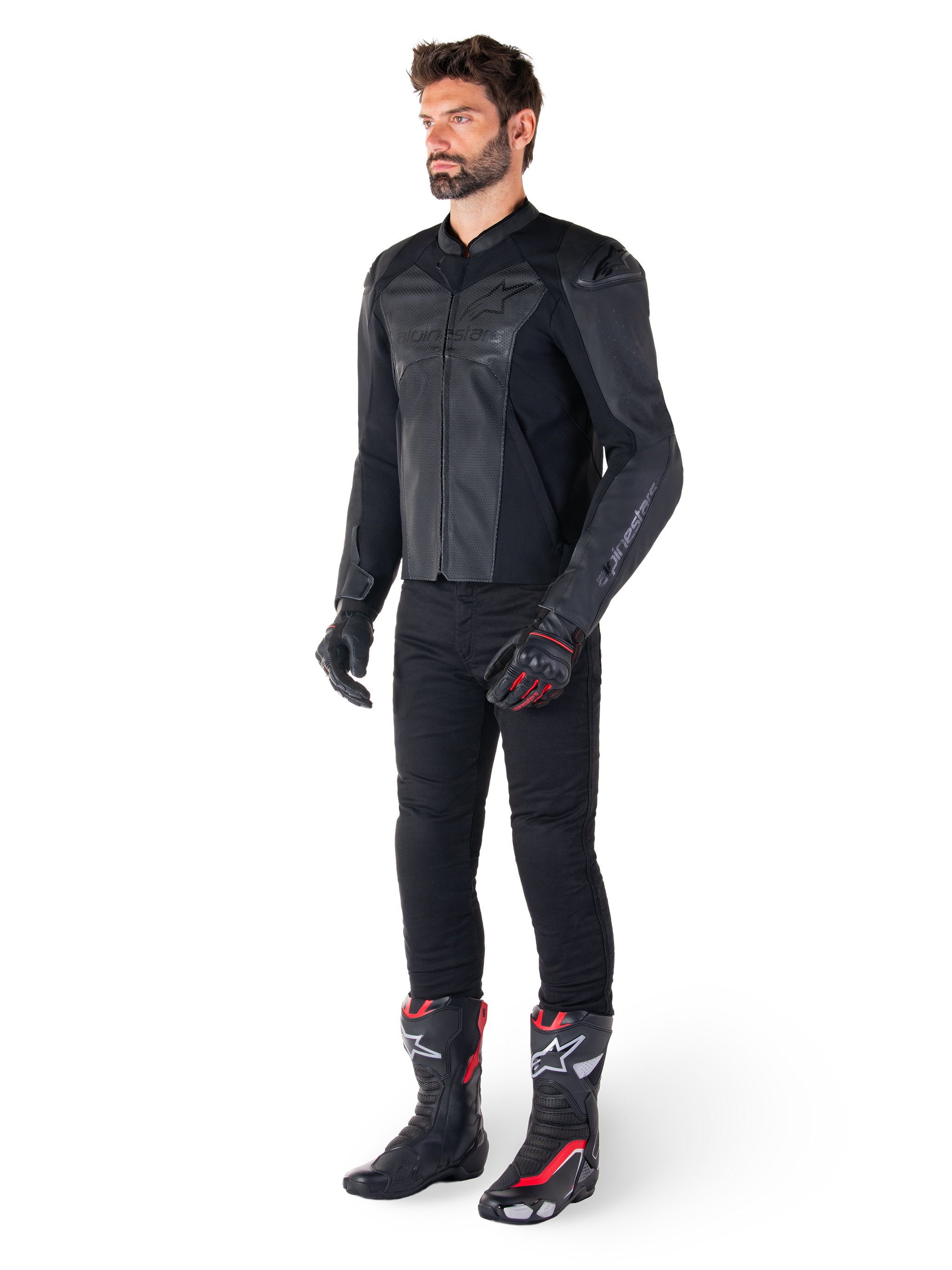 Man wearing Alpinestars Faster V3 Airflow Leather Jacket in Black Black, paired with black pants, black and red motorcycle gloves, and black racing boots with red and white accents, full-body sport riding gear