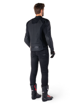 Alpinestars Faster V3 Airflow Leather Jacket, Black, Rear view of a man wearing a sport leather jacket with perforated back panels and Alpinestars branding, styled with black riding pants and black and red boots.
