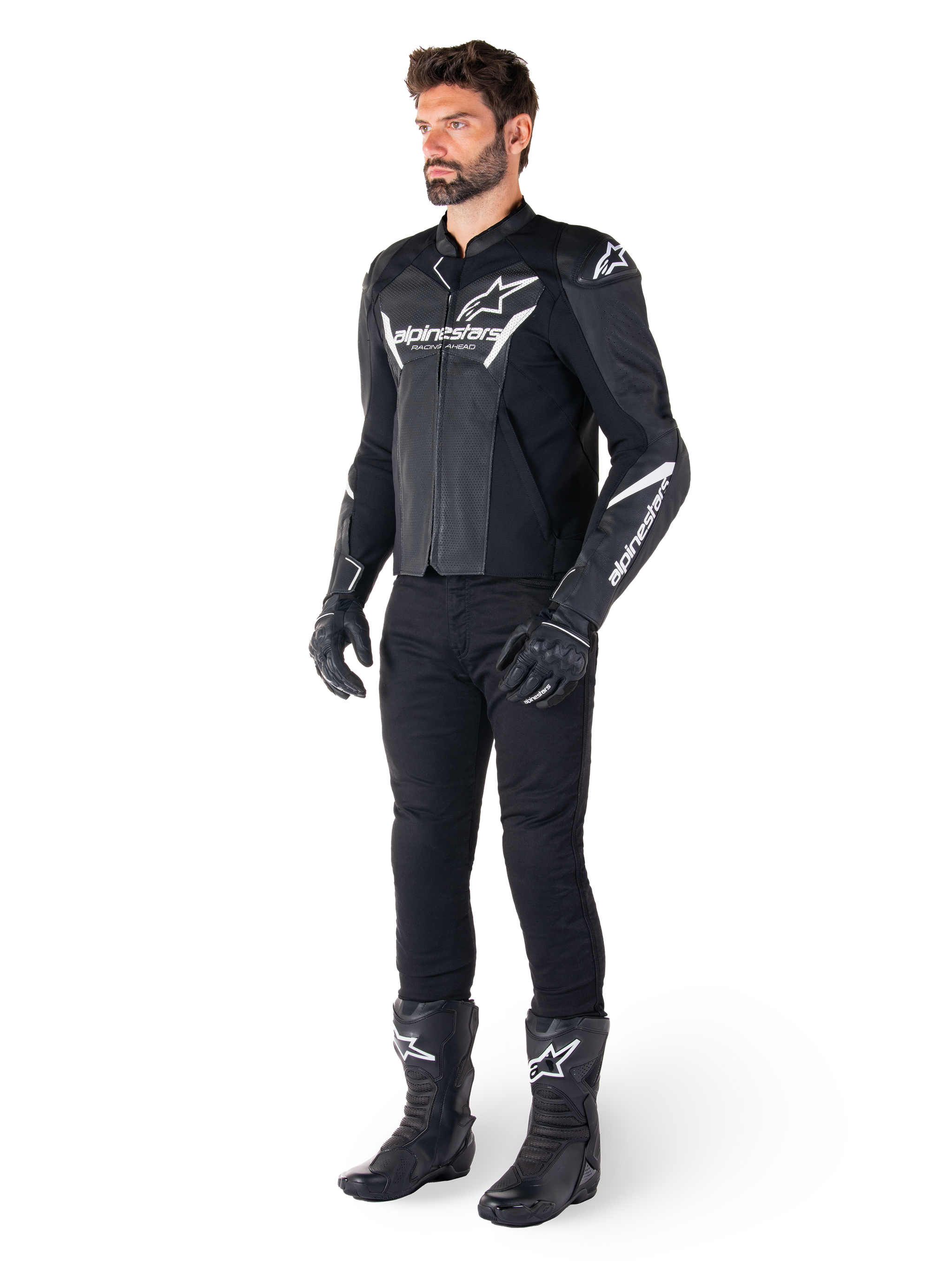 Model wearing Alpinestars Faster V3 Airflow Leather Jacket, Black and White, featuring perforated leather and white Alpinestars logos, paired with black riding pants, gloves, and boots, sport-focused motorcycle gear
