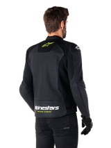 Alpinestars Faster V3 Airflow Leather Jacket, Black White and Yellow Fluo, rear view, featuring a large perforated leather back panel for ventilation, yellow star logo on the collar, and white Alpinestars branding with yellow 'Racing Ahead' text on the lower hem, sport motorcycle riding gear