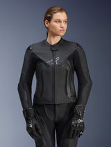 Alpinestars Stella GP Plus V4 Leather Jacket, Black, Women's Motorcycle Racing Jacket, premium leather construction with protective padding, sleek design with subtle logo, worn by a female model with matching black gear