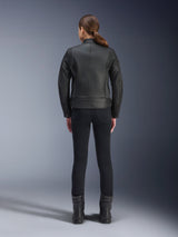 Alpinestars Stella Dyno Leather Jacket, Women's Motorcycle Jacket, Black, rear view highlighting the tailored bovine leather construction, minimalist heritage design, worn with black riding pants and boots for an urban motorcycle look