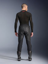 Alpinestars Missile V3 Leather Pants, Black, rear view on model wearing a black long-sleeve compression shirt and racing boots, premium leather construction with high-waist overlap and stretch zones, professional motorcycle racing gear
