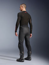 Alpinestars Missile V3 Leather Pants, Black, rear view on model, worn with a black long-sleeve base layer and black motorcycle racing boots, featuring accordion leather stretch panels and a pre-curved design for an ergonomic riding fit.