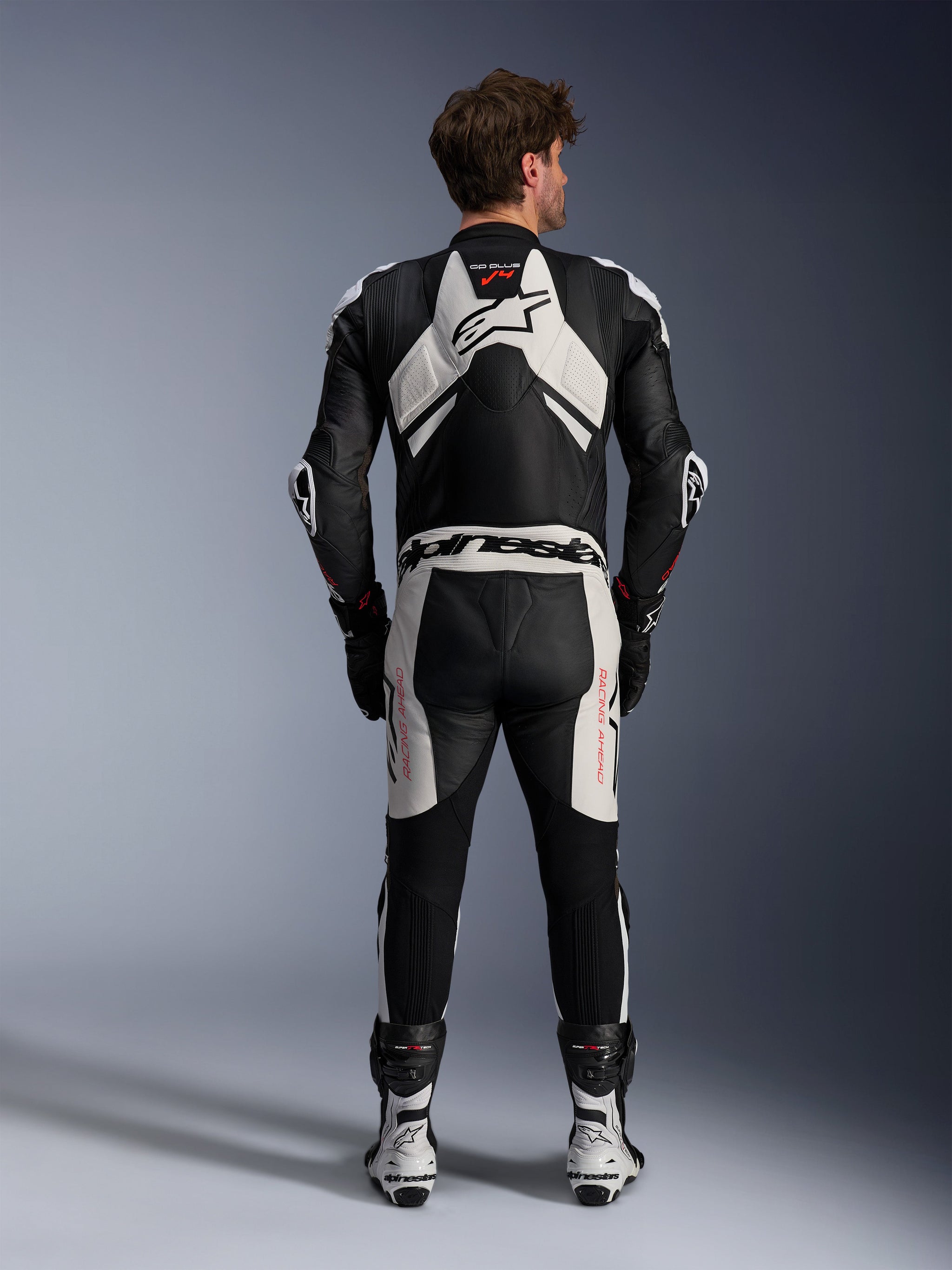 Alpinestars GP Plus V4 Sprint 1 Piece Leather Suit, Men's Racing Gear in Black and White with Red Fluo and aerodynamic hump.