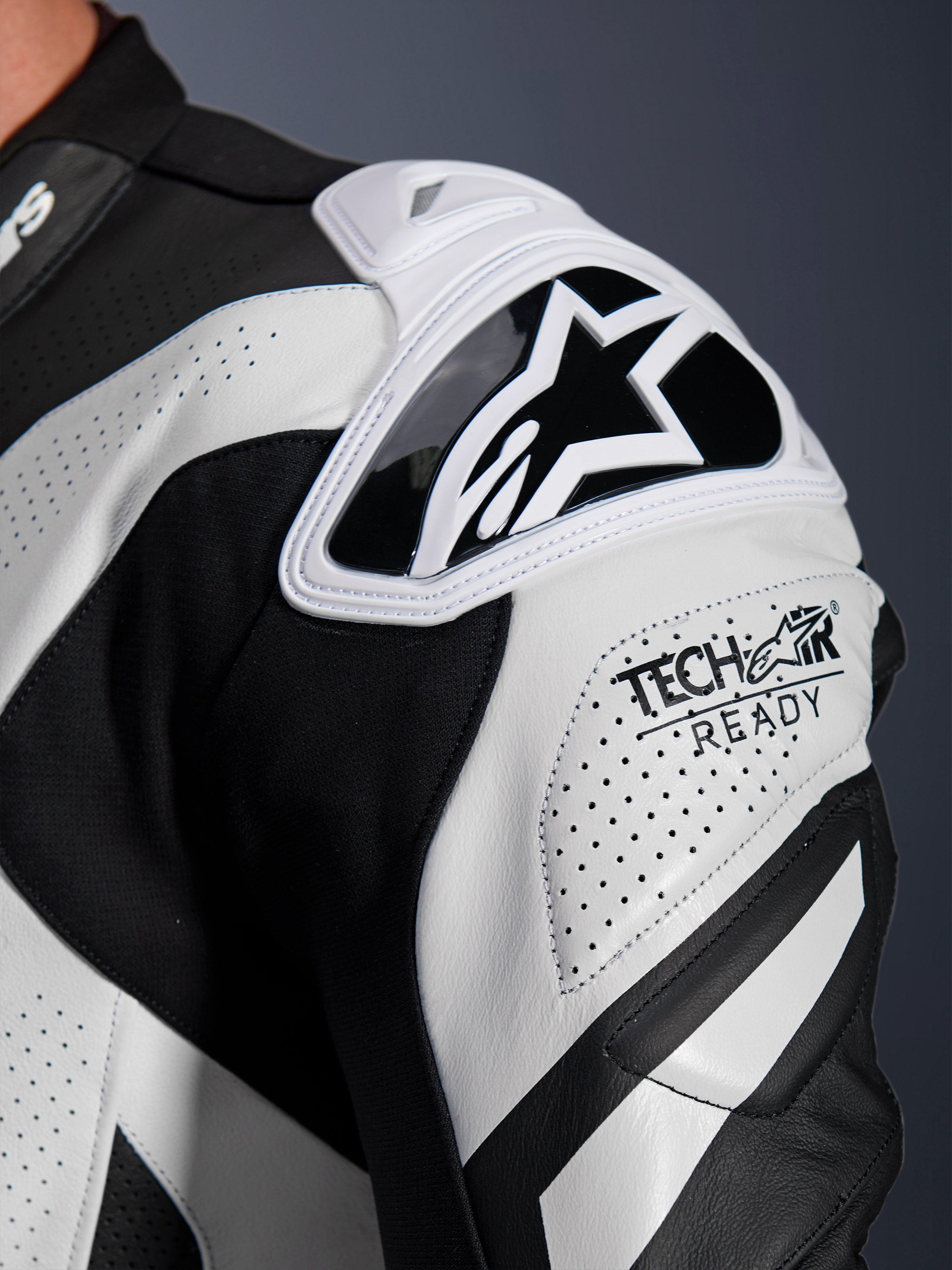 Alpinestars GP Plus V4 Sprint Leather Suit shoulder armor, black and white perforated leather with Tech-Air Ready logo.