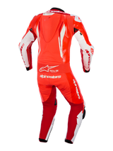 Alpinestars GP Tech V5 One Piece Leather Suit, Red Fluo Bright Red and White, rear view showing aerodynamic speed hump, flexible accordion waist panel, and prominent white Alpinestars branding, professional racing apparel for motorcycle track use.