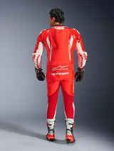GP Tech V5 One Piece Leather Suit, motorcycle racing suit, Red Fluo Bright Red and White, back view showing aerodynamic hump and white Alpinestars branding, worn with black and white racing gloves and boots.