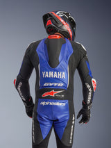 Alpinestars Yamaha GP-R7 One Piece Leather Suit, rear view, Metallic Blue and Black with white and red accents, prominent Yamaha and GYTR branding, featuring an aerodynamic speed hump, worn with a matching racing helmet and gloves for a professional track-ready look