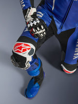 Alpinestars Yamaha GP-R7 One Piece Leather Suit, Motorcycle Suit, Metallic Blue and Black, featuring white and red Alpinestars logo on knee protection, replaceable GP knee slider, and matching blue racing boot, professional track-ready gear