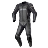 Black and gray motorcycle racing suit with reinforced shoulder, elbow, and knee protection, front zipper, aerodynamic design, padded impact zones, professional motorsport gear
