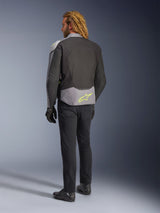 Alpinestars T-Jaws V4 Waterproof Jacket, back view, Black Ice Gray and Dark Gray, featuring a neon yellow Alpinestars logo on the lower back, worn with black pants and motorcycle gloves, sport-styled riding apparel
