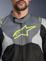 Alpinestars T-Jaws V4 Waterproof Jacket, Black Ice Gray and Dark Gray, close-up view of the chest and collar, featuring a bold neon yellow Alpinestars star logo and branding on the shoulders, durable textile material for motorcycle riding