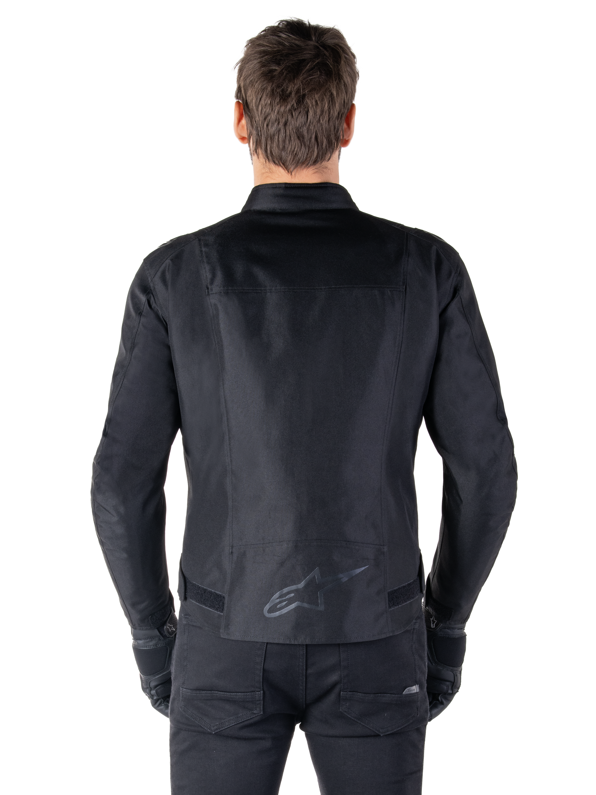 Alpinestars T-SPS V2 Waterproof Jacket, Black, back view showing the sport cut silhouette, reflective Alpinestars logo on the lower back, and extended back for extra coverage while riding.