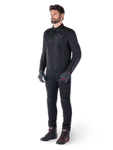 Alpinestars T-SPS V2 Waterproof Jacket, Black, worn by a male model with matching black pants, black gloves with red accents, and black riding shoes, full motorcycle gear for urban and sport riding, clean white background