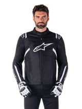 Alpinestars T-SPS V2 Waterproof Jacket in Black and White, front view on model, waterproof textile motorcycle jacket featuring white shoulder and arm stripes, large white Alpinestars logo on chest, worn with protective motorcycle gloves, sleek sport-inspired silhouette