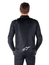 Alpinestars T-SPS V2 Waterproof Jacket, Back View, Black with Yellow Fluo accents on shoulders and white star logo on the lower back, Textile motorcycle jacket with a sport silhouette, Worn by male model.