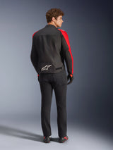 Alpinestars T-SPS V2 Waterproof Jacket, Black Red Red Fluo, back view on male model, white Alpinestars logo on the lower back, worn with black motorcycle pants and gloves, sporty textile waterproof riding jacket