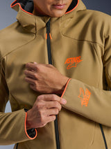 Alpinestars Aeroshell Waterproof Jacket, Dark Khaki and Orange Fluo, close-up of the front and sleeve featuring orange ASTARS logos, orange piping on the hood and cuffs, and a black waterproof zipper.