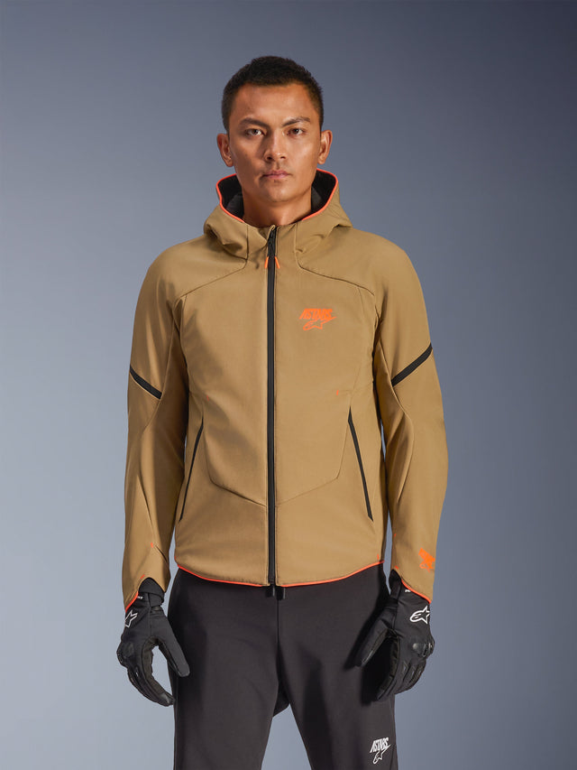 Alpinestars Aeroshell Waterproof Jacket, Dark Khaki hooded motorcycle jacket with orange logos and black zippers, black accent lines on sleeves, shown with black gloves and pants