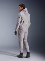 Alpinestars Aeroshell Waterproof Jacket, Mid Gray Yellow Fluo, worn with matching gray pants, featuring a hoodie design with yellow accents and logos, back view, paired with black riding gloves and boots, modern motorcycle apparel