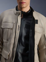Alpinestars Borrego Drystar® Jacket in Warm Gray, close-up view showing the unzipped front, black internal liner, and interior technical text including 'ALPINESTARS PROTECTS' and chest protector compatibility, rugged adventure motorcycle style.