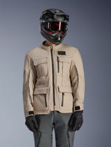 Alpinestars Borrego Drystar® Jacket, Adventure Motorcycle Jacket, Warm Gray, featuring multiple front cargo pockets and black zippers, worn with a black helmet, goggles, and dark gray riding pants, rugged textile design for touring