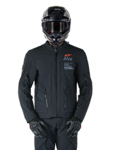 Alpinestars AMT-8 Stretch Drystar® XF Jacket, Black Motorcycle Jacket, featuring orange Alpinestars logo and grey AMT branding, high collar with front zipper and vents, worn with black helmet and gloves, protective adventure touring gear