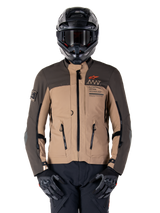 Alpinestars AMT-8 Stretch Drystar XF Jacket, Motorcycle Adventure Touring Jacket, Dark Khaki and Dark Brown, featuring orange Astars logo and black zippers, worn with black adventure helmet and gloves, full riding gear setup