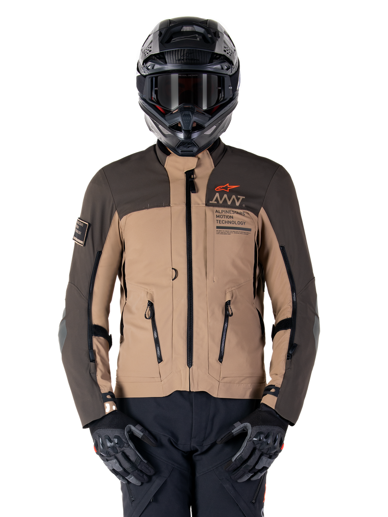 Alpinestars AMT-8 Stretch Drystar XF Jacket, Motorcycle Adventure Touring Jacket, Dark Khaki and Dark Brown, featuring orange Astars logo and black zippers, worn with black adventure helmet and gloves, full riding gear setup