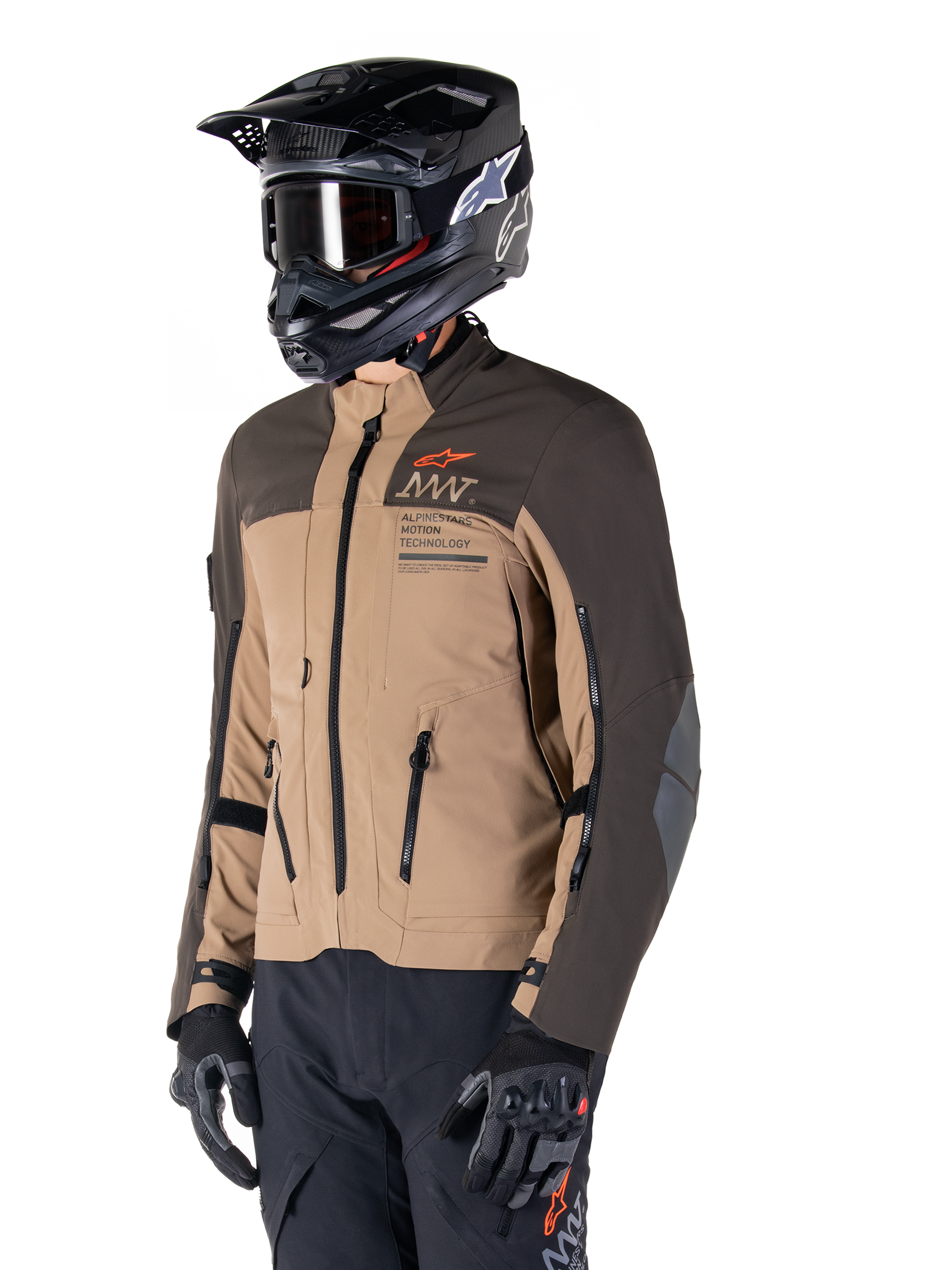 Alpinestars AMT-8 Stretch Drystar® XF Jacket, Adventure Motorcycle Jacket, Dark Brown and Dark Khaki, worn with a black off-road helmet and goggles, featuring Alpinestars Motion Technology branding and zippered ventilation ports.