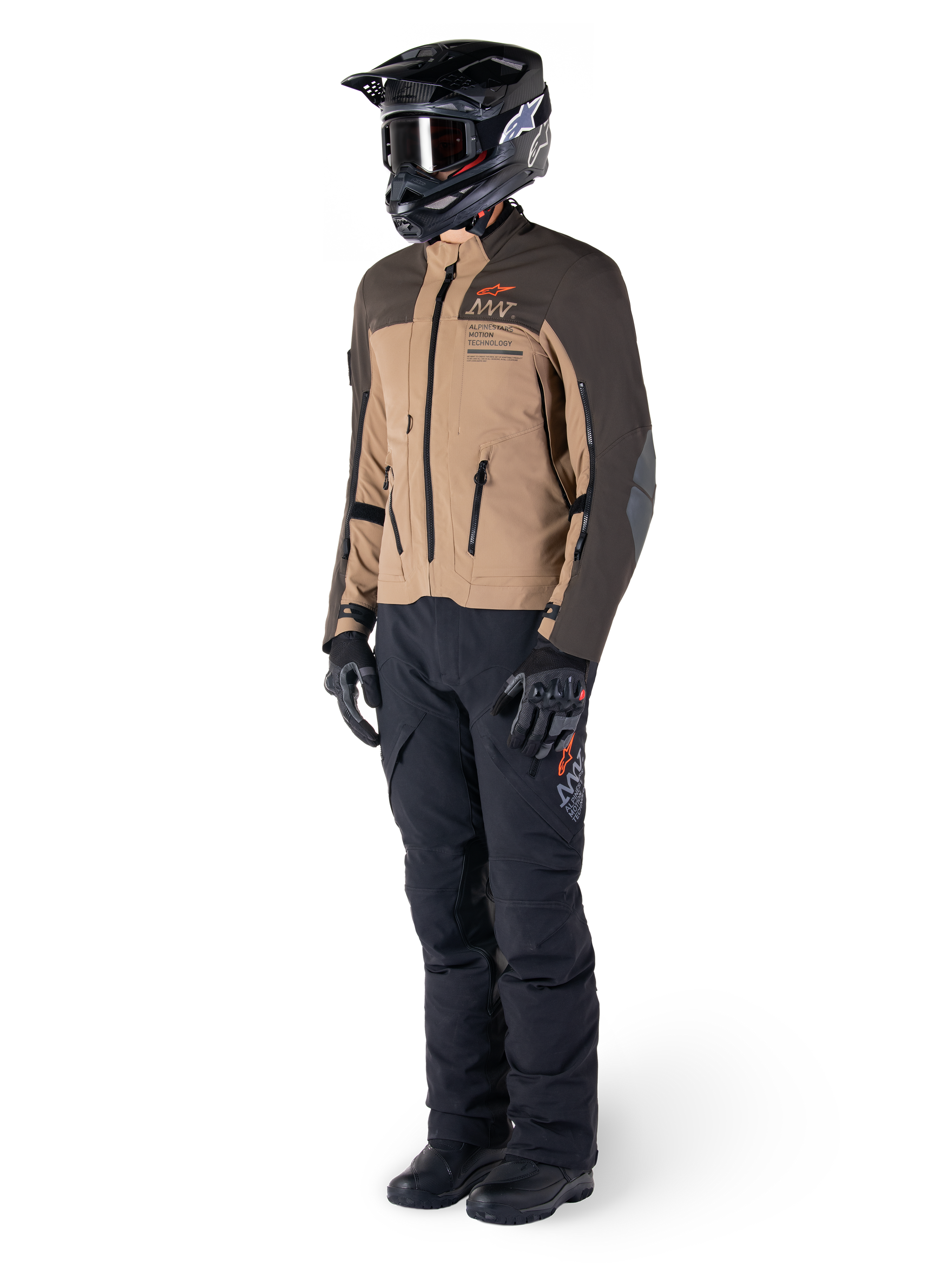 Adventure rider wearing complete gear, Alpinestars AMT-8 Stretch Drystar® XF Jacket in Dark Brown and Dark Khaki, paired with black adventure pants, black helmet, gloves, and boots, featuring orange AMT branding and technical ventilation zippers for long-range touring