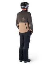 Alpinestars AMT-8 Stretch Drystar® XF Jacket, Adventure Touring Motorcycle Jacket, Dark Brown and Dark Khaki, rear view showing 'AMT Alpinestars Motion Technology' branding, worn with black pants and helmet, ergonomic stretch design for adventure riding