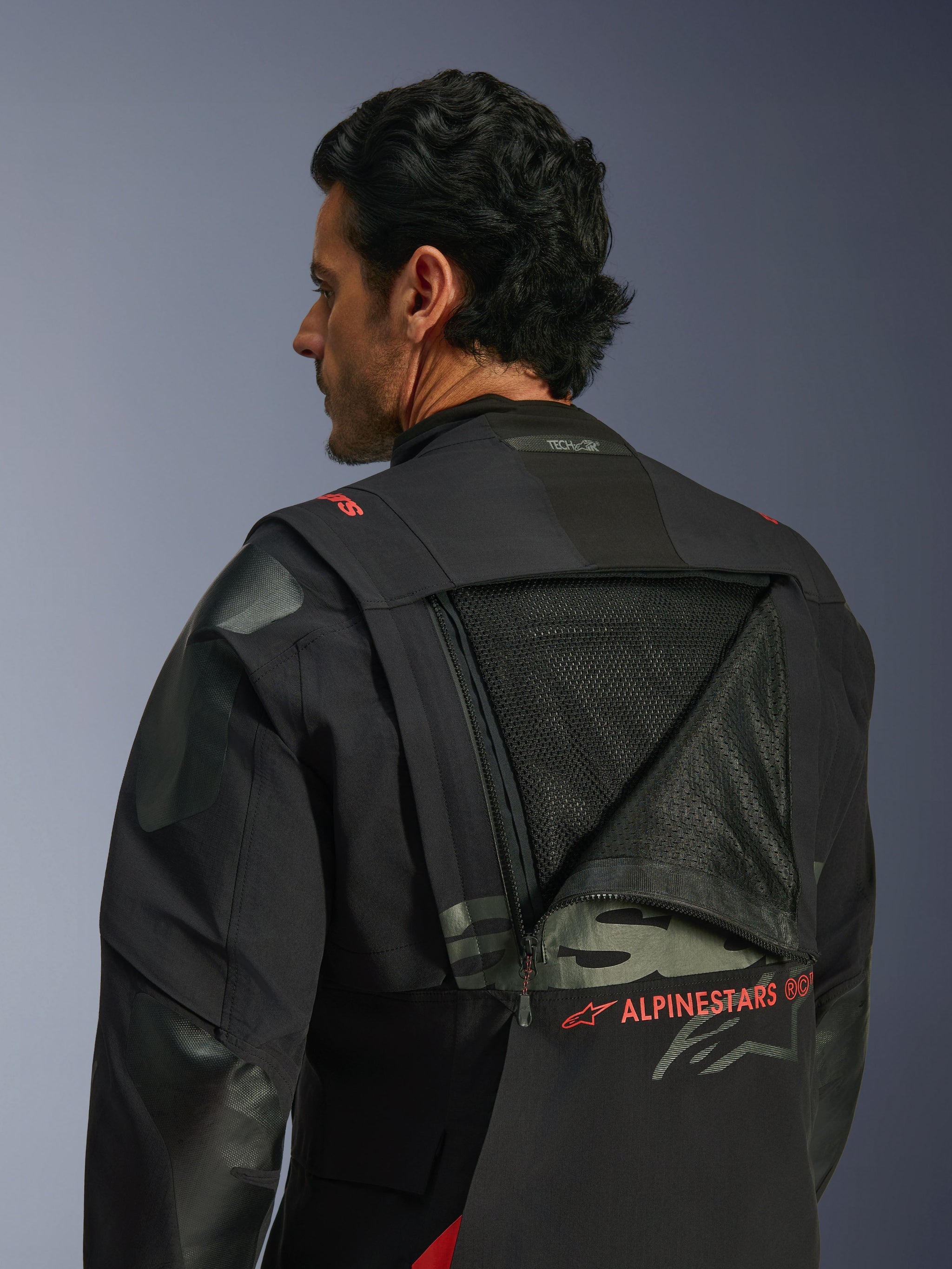 Alpinestars Halo Pro Drystar® XF Laminated Jacket, Adventure Motorcycle Jacket, Black Dark Shadow, back view featuring unzipped modular ventilation panel revealing large mesh area, red Alpinestars branding, Tech-Air® Ready logo on collar, durable textile construction for all-terrain riding.