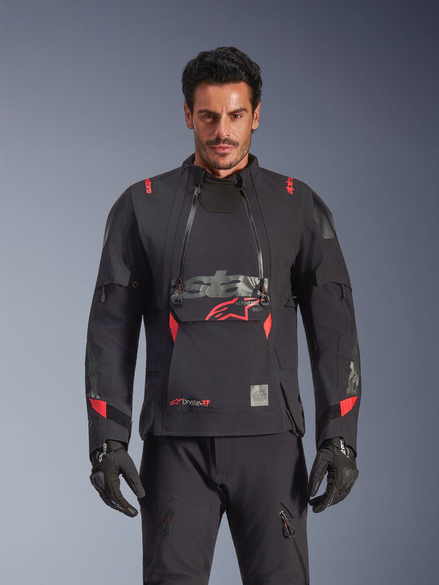 Alpinestars Halo Pro Drystar® XF Laminated Jacket, Adventure Motorcycle Jacket, Black Dark Shadow with red accents, male model wearing full technical gear including matching gloves and pants, front view highlighting modular chest ventilation panels and waterproof construction.