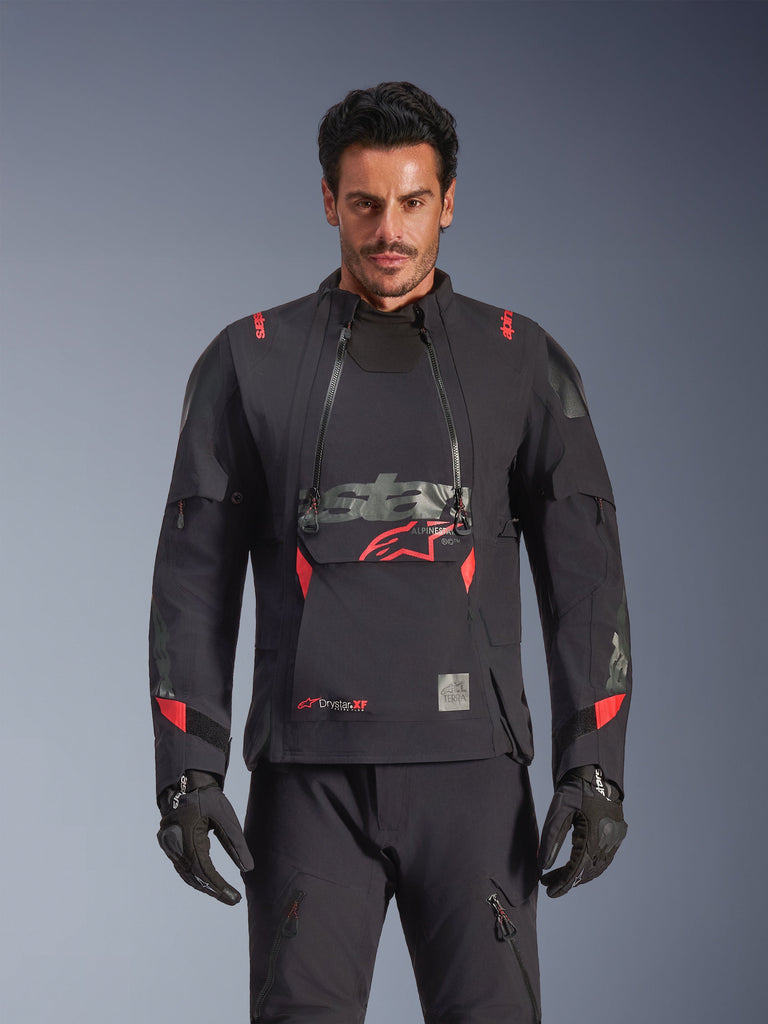 Alpinestars Halo Pro Drystar® XF Laminated Jacket, Adventure Motorcycle Jacket, Black Dark Shadow with red accents, male model wearing full technical gear including matching gloves and pants, front view highlighting modular chest ventilation panels and waterproof construction.