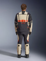 Alpinestars Halo Pro Drystar® XF Laminated Jacket, Adventure Motorcycle Jacket, Mastic Black with orange logo, rear view showing large back branding and modular ventilation zippers, worn with matching adventure pants for all-terrain performance