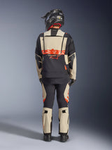 Alpinestars Halo Pro Drystar® XF Laminated Jacket, Adventure Motorcycle Jacket, Mastic Black, back view of a rider wearing matching pants and a black helmet, featuring bold orange Alpinestars branding and modular ventilation panels for versatile adventure riding.