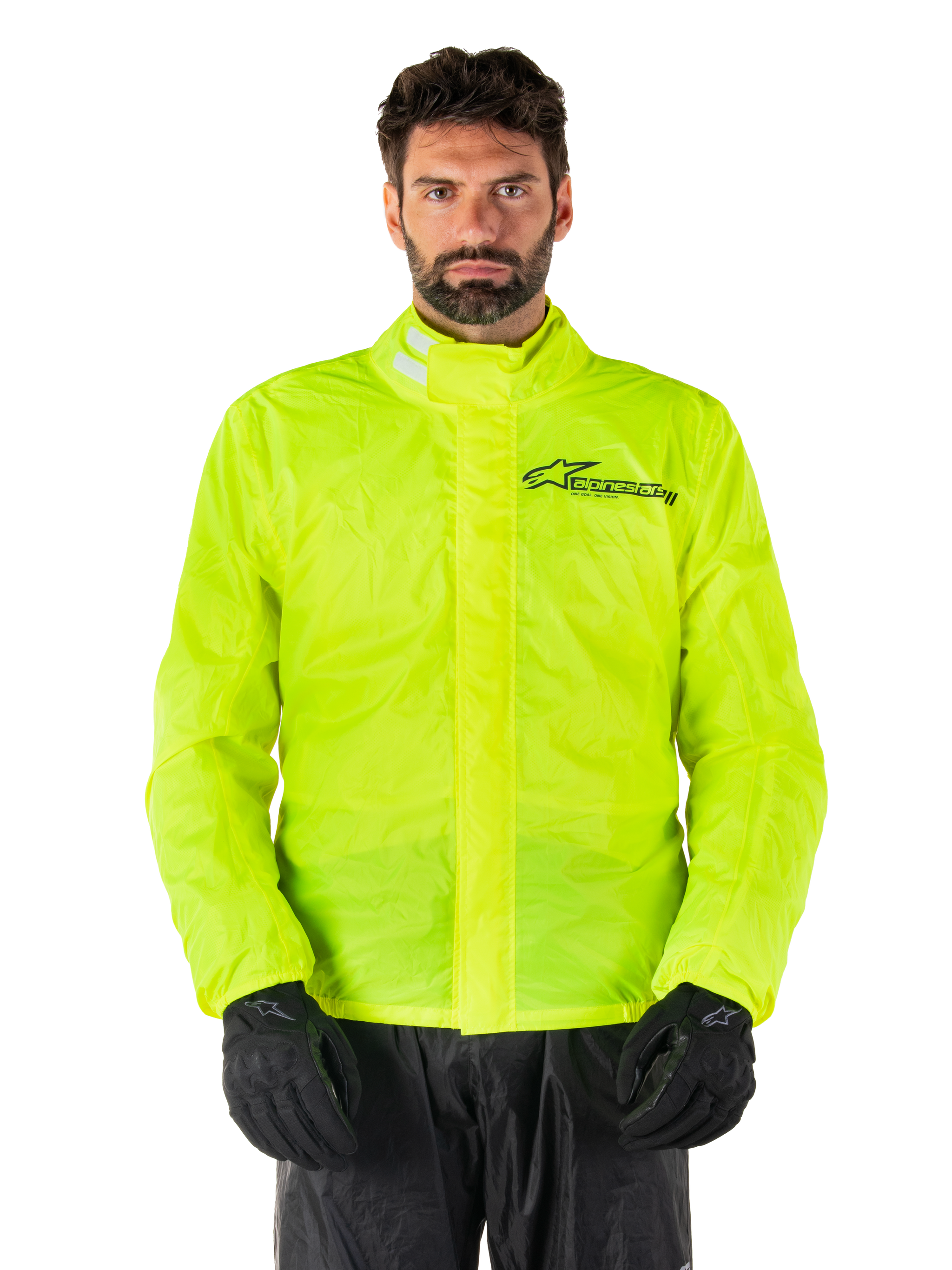 Alpinestars Hurricane Rain V2 Jacket, Motorcycle Rain Jacket, Yellow Fluo, worn by a model with black pants and gloves, high collar with reflective tabs, front storm flap with Alpinestars logo, high-visibility waterproof gear