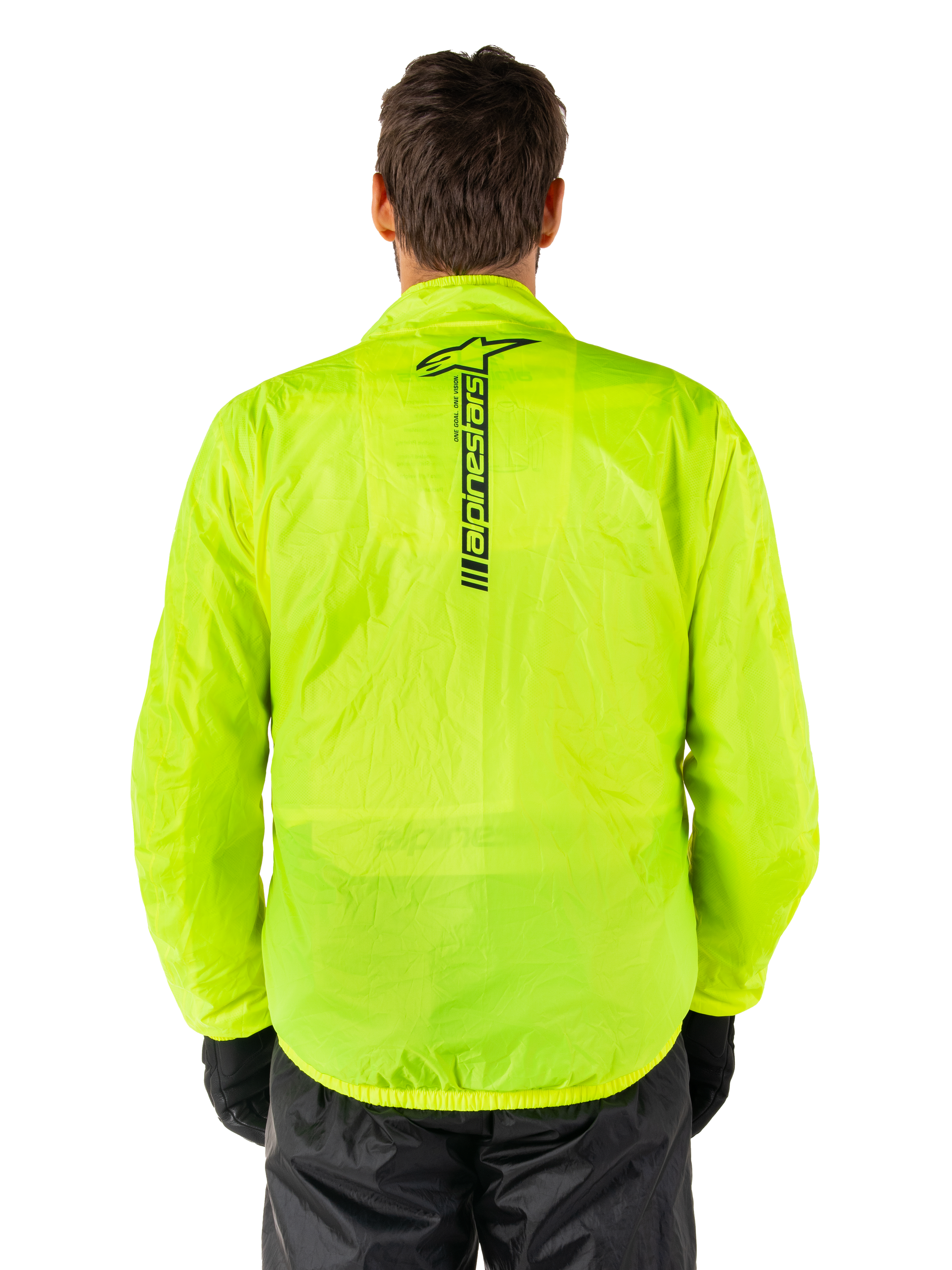 Alpinestars Hurricane Rain V2 Jacket, Motorcycle Rain Jacket, Yellow Fluo, rear view showing vertical black Alpinestars logo on center back, lightweight waterproof fabric, worn with black riding pants and gloves