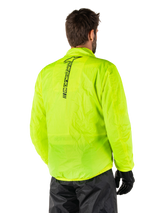 Alpinestars Hurricane Rain V2 Jacket, Yellow Fluo, rear view worn by male model, featuring vertical black Alpinestars wordmark on center back, elasticated waist and cuffs, waterproof and packable design