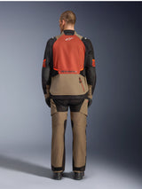 Alpinestars Andes V4 Drystar® Jacket, Walnut Rust Black, rear view of motorcycle touring jacket featuring rust-colored upper back panel and walnut lower section, worn with matching adventure pants and black boots