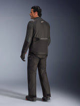 Alpinestars Andes V4 Drystar® Jacket, Black, back view of rider in complete motorcycle gear, textile adventure jacket featuring Alpinestars branding on the back, worn with matching black pants and boots, all-weather road and adventure riding style