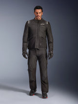 Male model wearing the Alpinestars Andes V4 Drystar® Jacket in Black, paired with matching adventure motorcycle pants, black gloves, and black boots, full-body studio shot showcasing technical all-weather touring gear with Alpinestars branding.