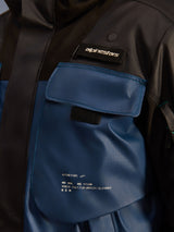 Alpinestars Mospher Waterproof Jacket, close-up detail of the chest pocket area, Black and Dark Petrol, durable ripstop fabric with printed 'One Goal. One Vision.' branding, utility-driven design with functional pockets and Alpinestars logo tab