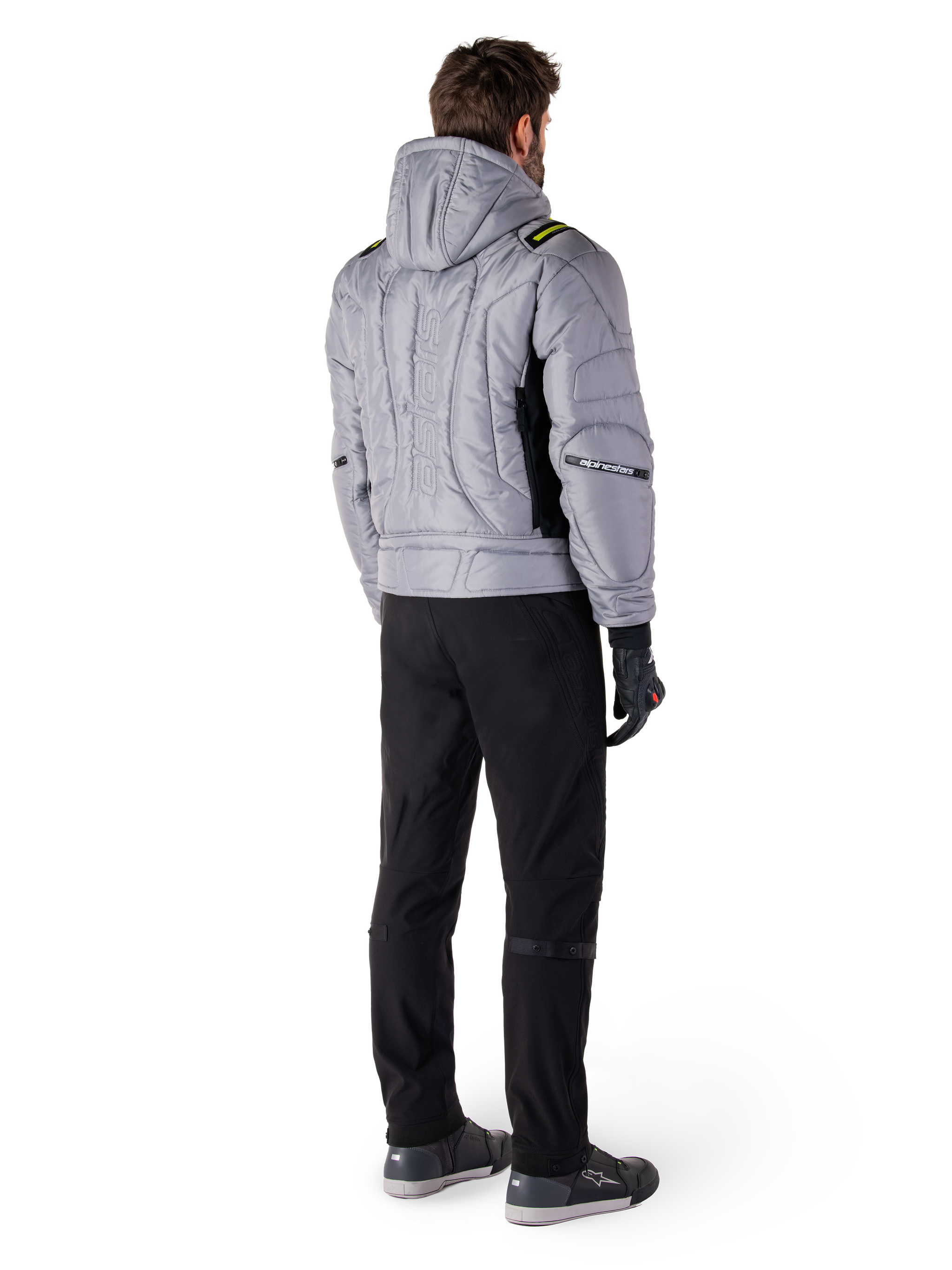 Alpinestars Mohobbs Waterproof Jacket, Lunar Gray Lime Punch, rear view of quilted bomber-style motorcycle jacket with hood, featuring Alpinestars wordmark on back, worn with black riding pants and gloves, urban moto streetwear