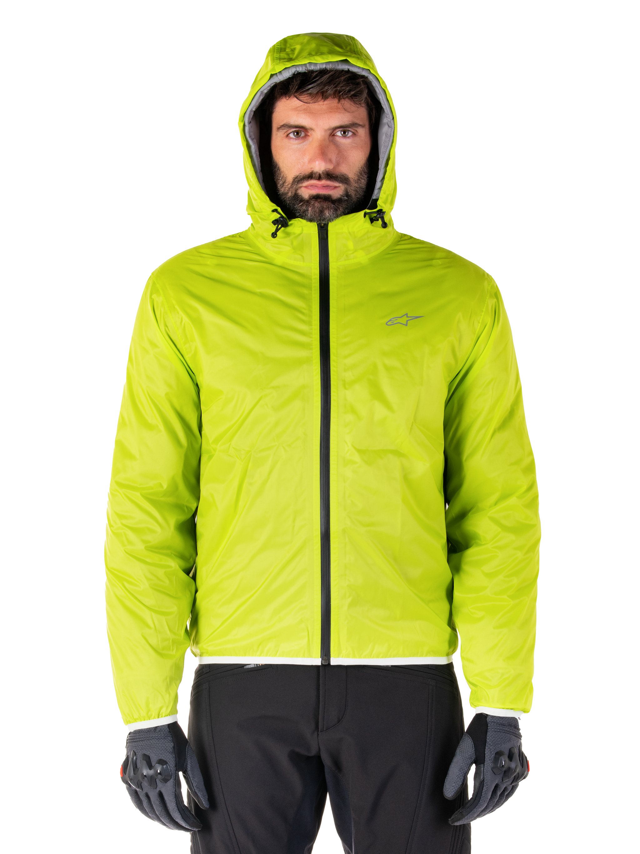 Alpinestars Mohobbs Waterproof Jacket, Lime Punch packable raincover, bright lime green hooded shell worn with black riding pants and gray motorcycle gloves, urban moto-streetwear style.