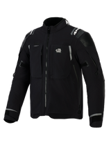 Alpinestars Andes Pro Drystar® XF Jacket, Black and Dark Gray adventure motorcycle jacket, front angled view, featuring 'ALL TERRA' chest logo, reflective branding on shoulders, multiple waterproof zippered pockets, and adjustable sleeve cuffs.